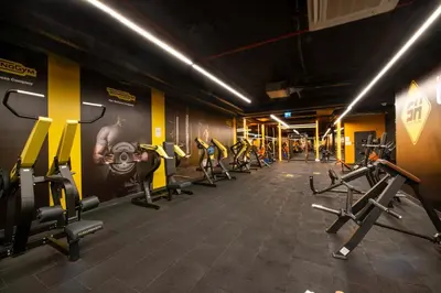 a gym with rows of treadmills and machines at The Craton Hotel Sisli in Istanbul