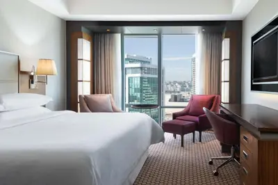 a hotel room with a bed and a large window at Sheraton Bursa Hotel in Bursa