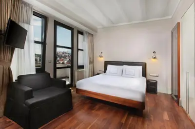 a bedroom with a white bed and a chair at The Haze Karaköy in Istanbul