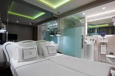 a bedroom with a white bed and a bathroom at The Haze Karaköy in Istanbul