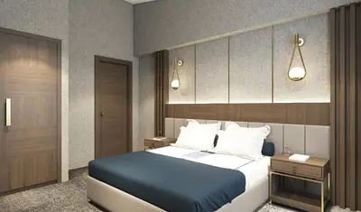 a bedroom with a large bed with a blue blanket at Arts Hotel Taksim in Istanbul