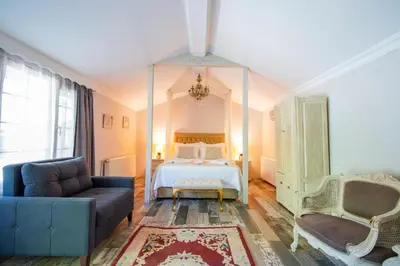 a bedroom with a bed and a couch at Ağva Acquaverde Otel in Agva
