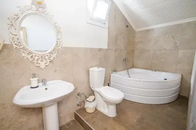 a bathroom with a sink toilet and a mirror at Ağva Acquaverde Otel in Agva