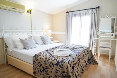 a bedroom with a large white bed and a window at Ağva Acquaverde Otel in Agva