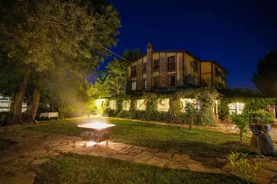 a house with a bench in front of it at night at Ağva Acquaverde Otel in Agva