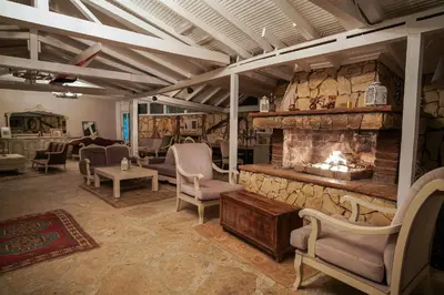 a living room with chairs and a fireplace at Ağva Acquaverde Otel in Agva