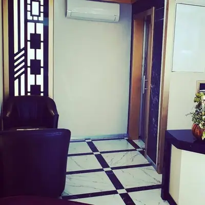 a room with a door and a chair and a tile floor at Hivas Hotel in Istanbul