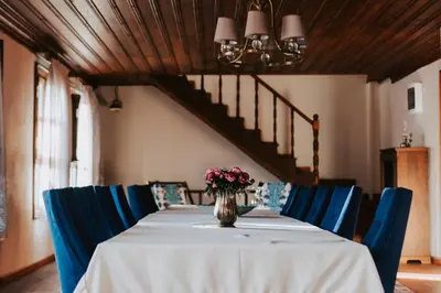 a table with blue chairs and a vase with flowers on it at Misgibi Hotel in Bursa