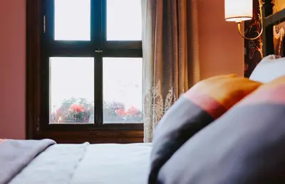 a bedroom with a window with a bed and a pillow at Misgibi Hotel in Bursa
