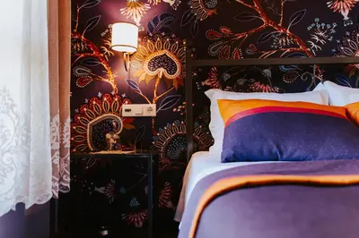 a bedroom with a bed with a floral wallpaper at Misgibi Hotel in Bursa