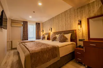 a hotel room with a large bed and a television at Avrasya Port Hotel in Istanbul