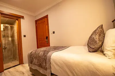 a bedroom with a bed and a glass door at Avrasya Port Hotel in Istanbul