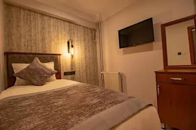 a hotel room with a bed and a television at Avrasya Port Hotel in Istanbul