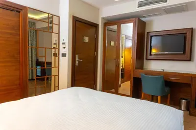 a hotel room with a bed and a television at Long Stay İstanbul Hotel in Istanbul