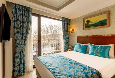 a bedroom with a bed and a large window at Rast Hotel Sultanahmet in Istanbul