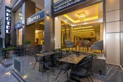 a restaurant with tables and chairs in front of a store at 38 Hotel in Istanbul