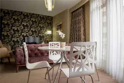 a living room with a table and chairs and a couch at My Palace Aırport in Istanbul