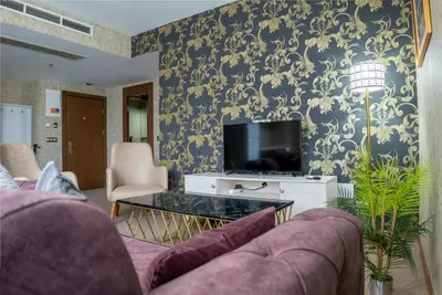 a living room with a couch and a tv at My Palace Aırport in Istanbul