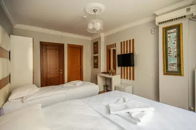 a bedroom with two beds with towels on them at Maduro Hotel Istanbul in Istanbul