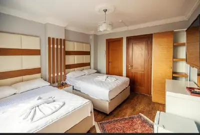 a hotel room with two beds and a bathroom at Maduro Hotel Istanbul in Istanbul