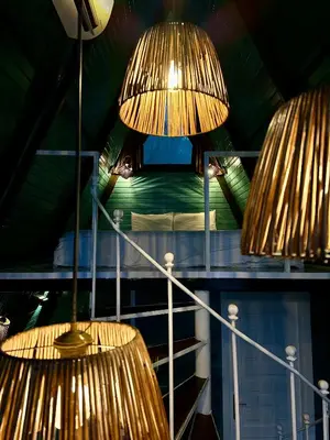 two hanging lights in a room with a bed at Kadifeli Konak Hotel & Bungalow in Kocaeli