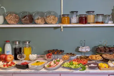 a buffet filled with different types of food on shelves at Nika otel & cafe in Istanbul