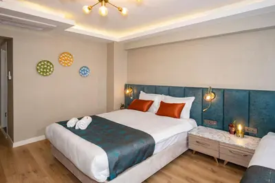 a bedroom with a large bed with a blue headboard at Nika otel & cafe in Istanbul
