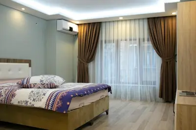 a bedroom with a bed and a large window at Sare House in Istanbul