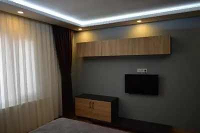 a bedroom with a flat screen tv on a wall at Sare House in Istanbul