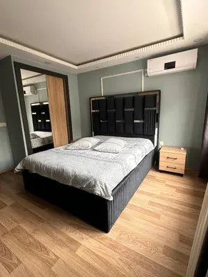 a bedroom with a large bed and a mirror at Sare House in Istanbul
