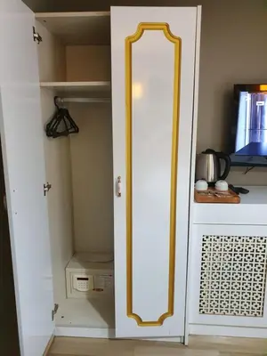 a white closet with a mirror on the door at Şehir Hotel Old City in Istanbul