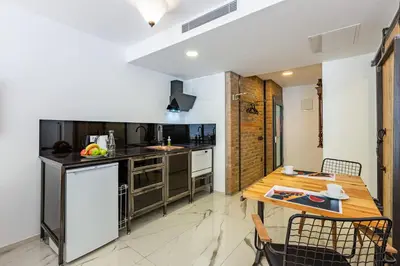 a kitchen with a wooden table and a dining room at Villa Pera Suite Hotel in Istanbul
