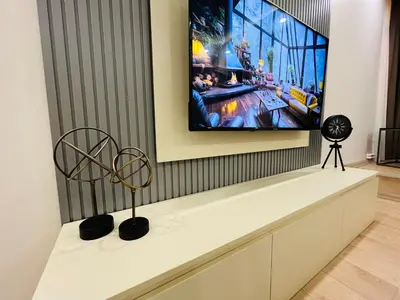 a living room with a tv on a wall at Westley Residence Taksim in Istanbul