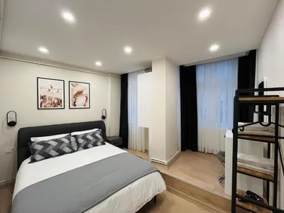a bedroom with a bed and a staircase in it at Westley Residence Taksim in Istanbul