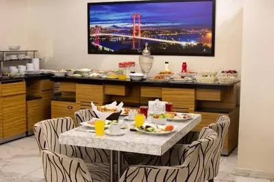 a dining room with a table with food on it at Vizyon Hotel - Old City in Istanbul