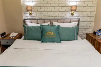 a bed with green pillows and a pillow that says the only one at Interstar Hotel - Sultanahmet in Istanbul