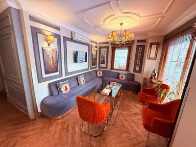 a living room with a blue couch and orange chairs at Interstar Hotel - Sultanahmet in Istanbul