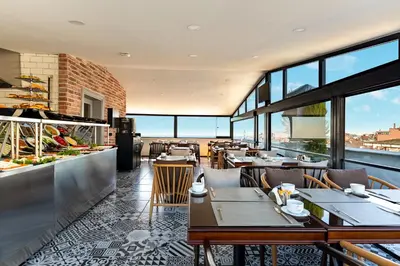 a restaurant with tables and chairs and windows at Interstar Hotel - Sultanahmet in Istanbul