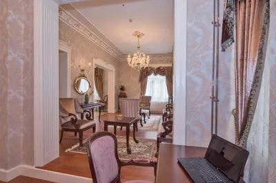 a living room with a laptop on a desk at Enderun Hotel Istanbul in Istanbul