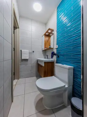 a bathroom with a white toilet and a sink at ROYAL TAKSIM SUITES in Istanbul