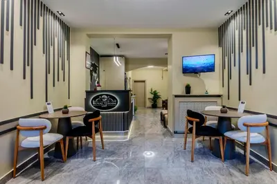 a restaurant with two tables and chairs and a fireplace at ROYAL TAKSIM SUITES in Istanbul
