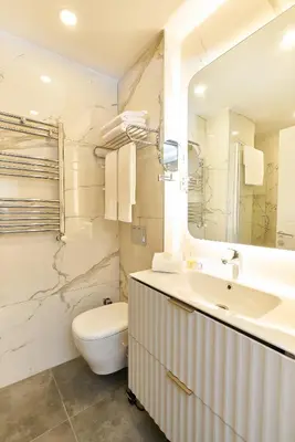 a white bathroom with a sink and a toilet at All Seasons Suites in Istanbul