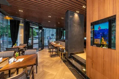 a restaurant with tables and chairs and a large fireplace at Opale Hotel in Istanbul