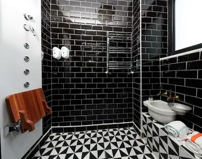 a black tiled bathroom with a sink and a mirror at Faik Pasha Hotels Special Category Beyoglu Istanbul in Istanbul