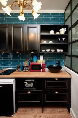a kitchen with black cabinets and a counter with a microwave at Faik Pasha Hotels Special Category Beyoglu Istanbul in Istanbul