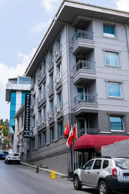 a large building with cars parked in front of it at Malta Bosphorus Hotel in Istanbul
