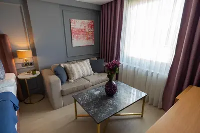 a living room with a couch and a table at Malta Bosphorus Hotel in Istanbul
