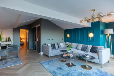 a living room with a white couch and blue walls at Malta Bosphorus Hotel in Istanbul