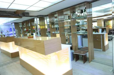 a kitchen with wooden cabinets and a counter top at Bursa Palas Hotel in Bursa