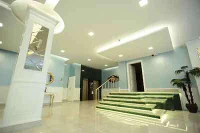 a lobby with a staircase with green steps at Bursa Palas Hotel in Bursa